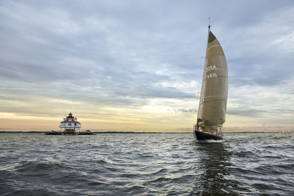 Sailboat racing past Thomas Point Lighthouse