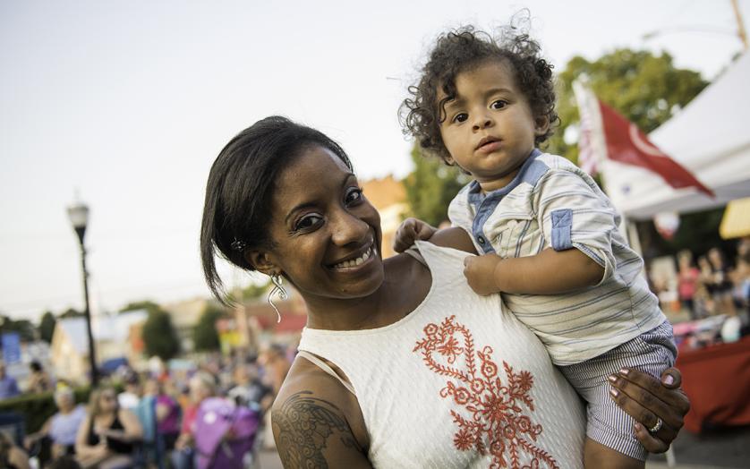 Mom holding child at Festival
