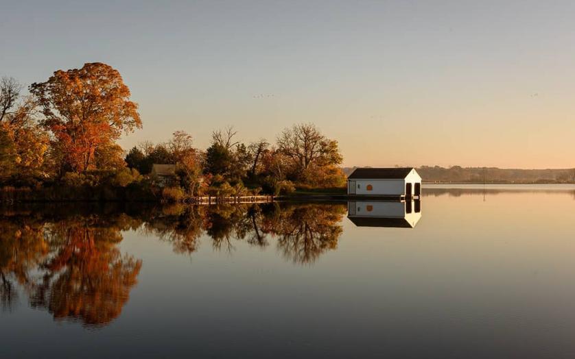 Autumn colors reflect on the still river at Blackwater National Wildlife Refuge